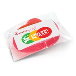A red silicone wristband in packaging, featuring a logo. Ideal for exhibitions and events.
