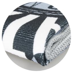 A grey and white sports towel, folded with a textured surface and featuring a logo.