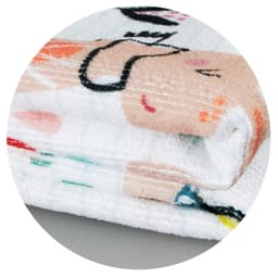 A folded Zen Yoga Towel featuring a playful design with soft pastel colours and a logo.