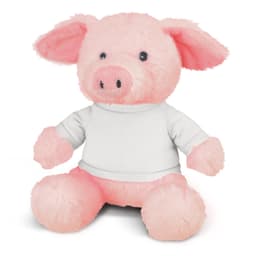 A pink pig plush toy with a soft texture and dressed in a white shirt sits upright. It has a friendly expression and rounded features.