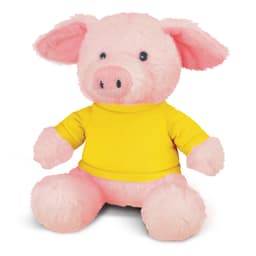 A pink plush pig toy wearing a yellow shirt, featuring large ears and a cute face. It has a logo on the shirt.