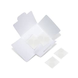 A white packaging box open to reveal circular stickers inside. The box has a logo on it.