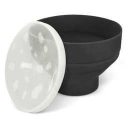 A black silicone microwave popcorn popper with a transparent lid featuring white spots.