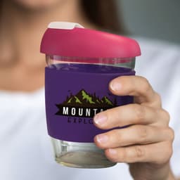 A drink bottle featuring a transparent borosilicate design, with a pink lid and a purple silicone sleeve.