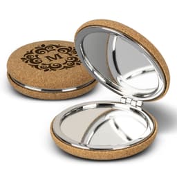 A cork compact mirror featuring a decorative design and a shiny interior for reflection.