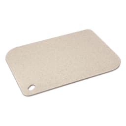 A light beige chopping board with a rounded corner and a hole for hanging. It features a smooth, speckled surface and has a logo.