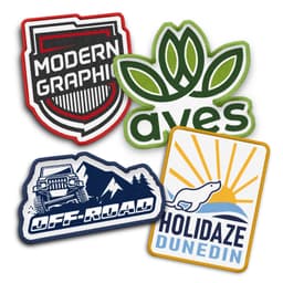 Custom woven patches featuring various designs in blue, green, red, and yellow, including logos and graphic elements.