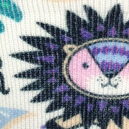 A close-up of a patterned sock featuring a colourful lion design with purple and pink accents.