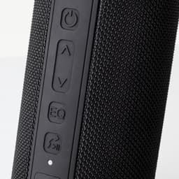 A black Bluetooth speaker featuring textured material and control buttons on the side. Contains a branding logo.