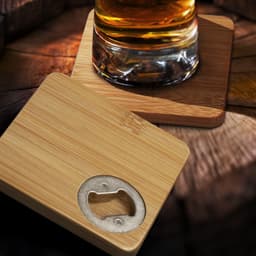 A drink bottle opener coaster set of two, in natural bamboo with a metallic bottle opener in one.