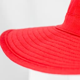 A red Legionnaire wide brim hat with a textured brim, featuring a logo on the side.