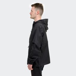 A black windbreaker jacket with a hood, featured on a model in profile view. 