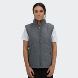 A grey puffer vest with a front zipper and side pockets, worn by a model against a plain background.