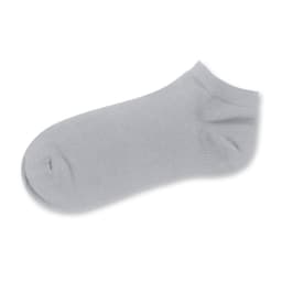 A grey ankle sock with a soft texture and a logo on the side.