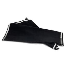 A black terry golf towel with a textured surface and contrasting stripes, featuring a logo.