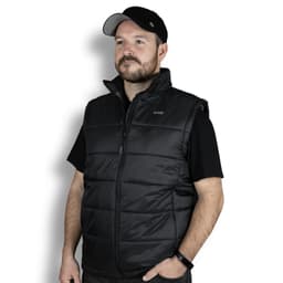 A man wearing a black puffer vest, featuring a zip front and a collar, with a logo on the upper left.