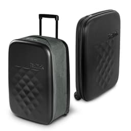 A small suitcase in green fabric with a black, quilted hard shell and a retractable handle. Brand logo visible.