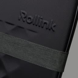 A close-up of a black suitcase featuring a textured surface and an attached dark green strap. It has a logo visible.