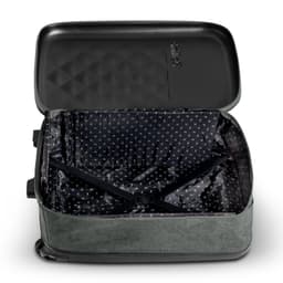 A medium, wheeled suitcase in green with a patterned interior, featuring an open, empty compartment and a logo.