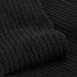 A black ribbed texture of a scarf and beanie set. The fabric appears soft and warm. Features a brand logo.