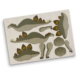 A wooden model kit featuring a green Stegosaurus shape with brown accents, including its iconic plates and tail.