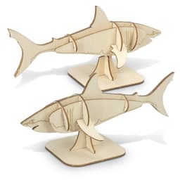 A natural wood model of a shark, featuring intricate cut-out designs, displayed on a flat base.