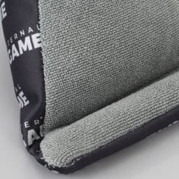 A green and black bean bag phone holder with a textured surface and a branding logo.