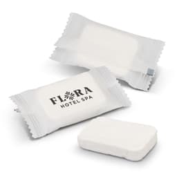 Compressed towels in white packaging, with an accompanying towel in a rectangular shape. One package features a logo.