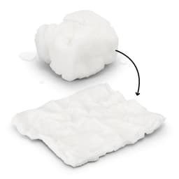 A compressed white towel, transforming from a small compact shape to a flat, textured cloth, with water droplets nearby.