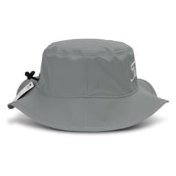 A grey bucket hat with a wide brim and an adjustable cord, featuring a logo on the side.