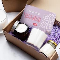 A6 message card in lavender with candles and a jar of bath salts, displayed in a brown gift box with purple filler.