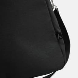 A black duffle bag with a subtle texture and an attachment point for a strap, featuring a small logo.