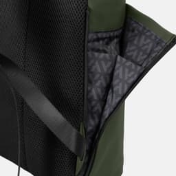 A soft-touch flap backpack in black and green, featuring a textured exterior and a patterned interior with pockets.