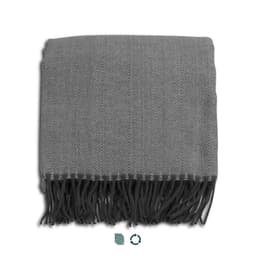 A grey herringbone throw blanket featuring fringe detailing. The blanket is neatly folded. It has a logo.