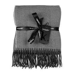 A grey herringbone throw blanket wrapped with a black ribbon and tag, featuring fringed edges.