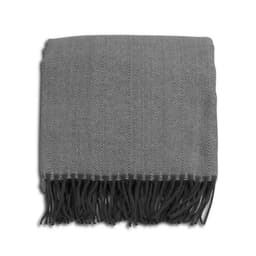 A grey herringbone throw blanket with fringe detailing, neatly folded. It has a subtle pattern and a soft texture.