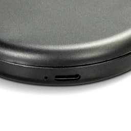 A compact mirror in a sleek black finish with a USB-C charging port on the side.