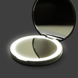 A round, silver compact mirror with an LED light surrounding the edge, opened to reveal a reflective interior.