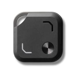A black Bluetooth tracker featuring a metal button and a small opening, with a minimalist design.