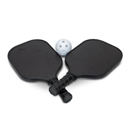 Two black pickleball paddles and a white perforated ball, arranged together. The paddles have grips and a logo.