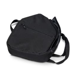 A black bag with a zippered pocket and adjustable strap, suitable for carrying sports gear.