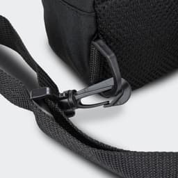A black crossbody bag featuring a mesh panel and a secure clip on the strap. It has a simple, functional design.
