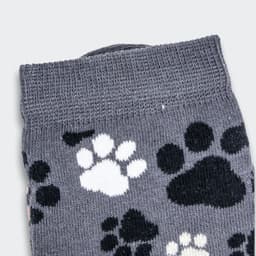 Grey knitted kids' socks featuring a playful pattern of black and white paw prints.