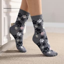 Grey knitted kids' socks featuring colourful paw print patterns in pink, white, and black.