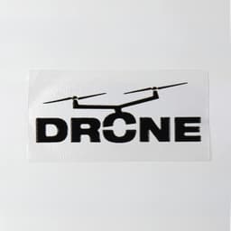 A 40 x 20mm sticker featuring a black drone graphic and the word "DRONE" on a white background.