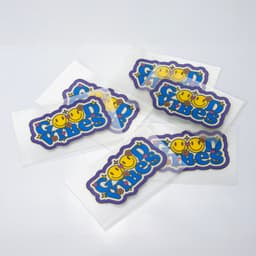 A collection of colourful stickers featuring playful designs and a logo on a white background.