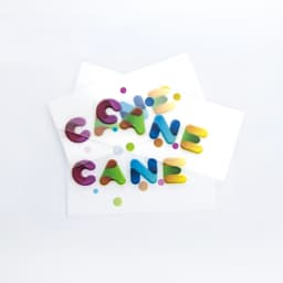 A vibrant, multicoloured sticker sheet featuring playful, raised letters and colourful dots against a white background.