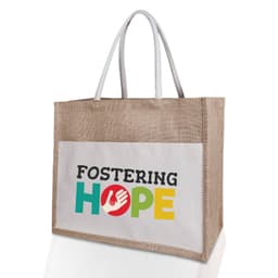 A jute canvas bag in natural tones with a large white pocket featuring multicoloured text and a logo.