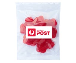 A packet containing red gummy lollies shaped like frogs. The bag features a logo.