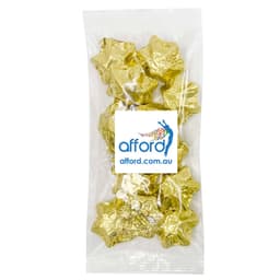 A clear package containing gold foil-wrapped star-shaped chocolates. The pack features a logo on the front.